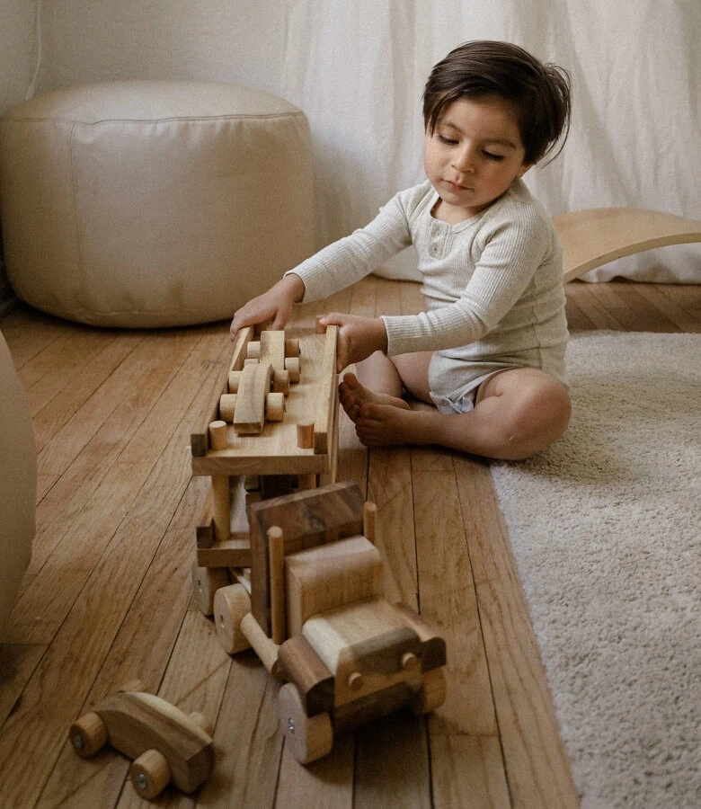 boy playing with transport truck