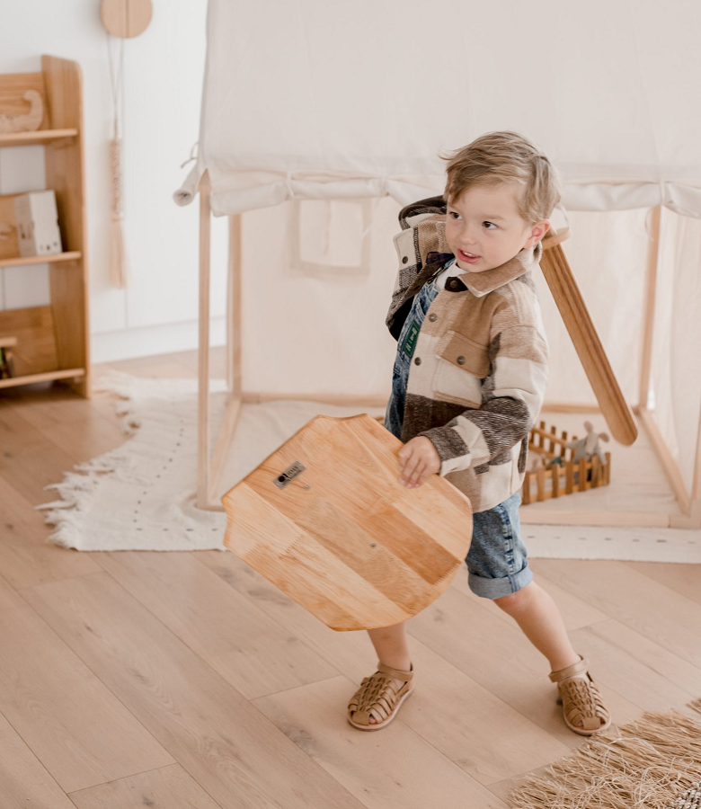 child playing with wooden sword set