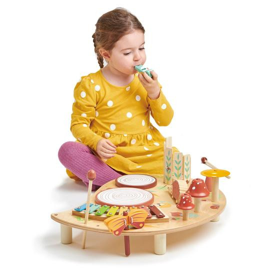 girl playing with woodland musical table