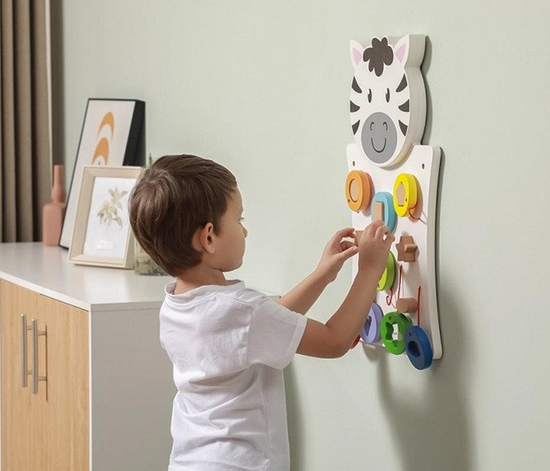 boy playing with zebra wall game shapes matching