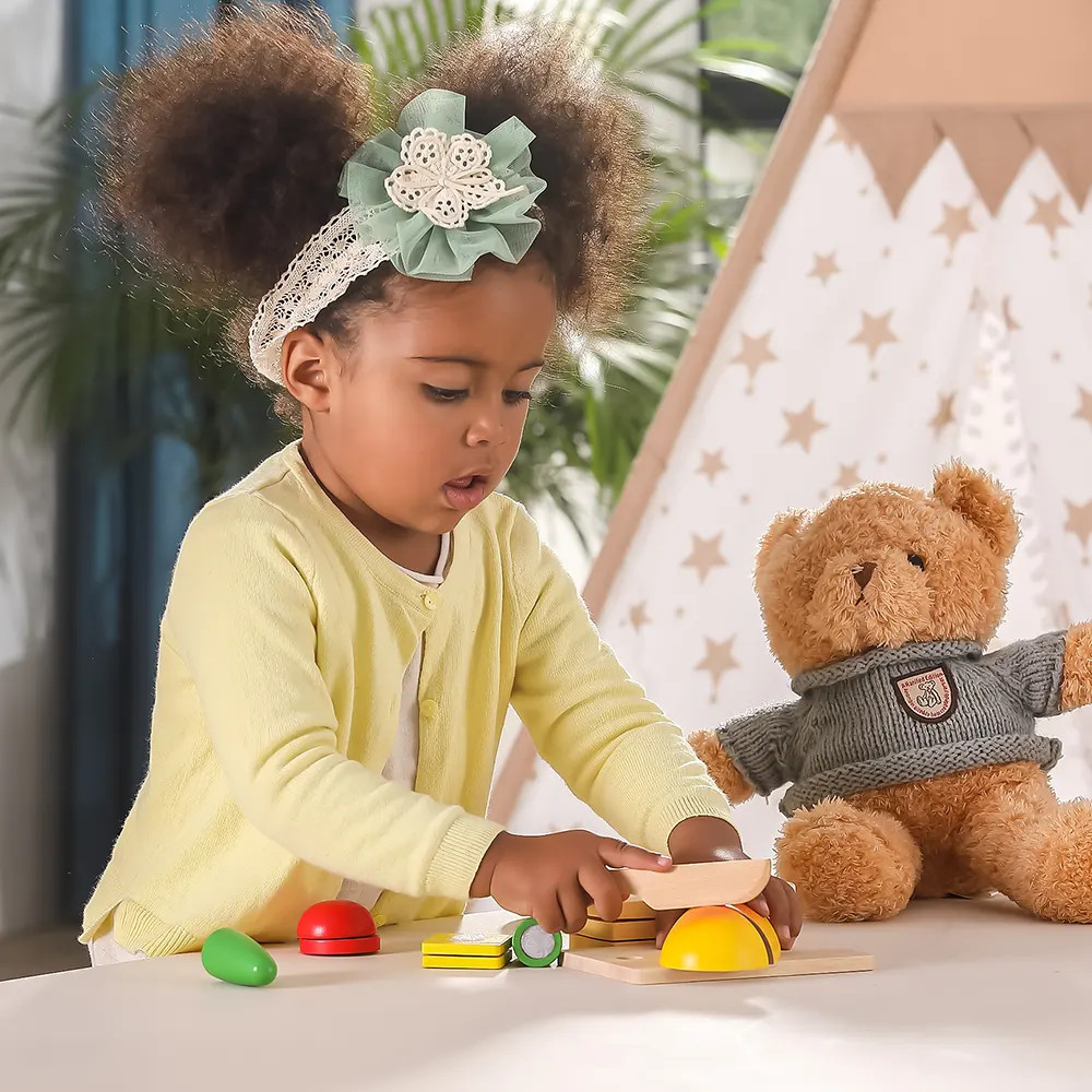 girl playing with pretend play breakfast cutting set with velcro items