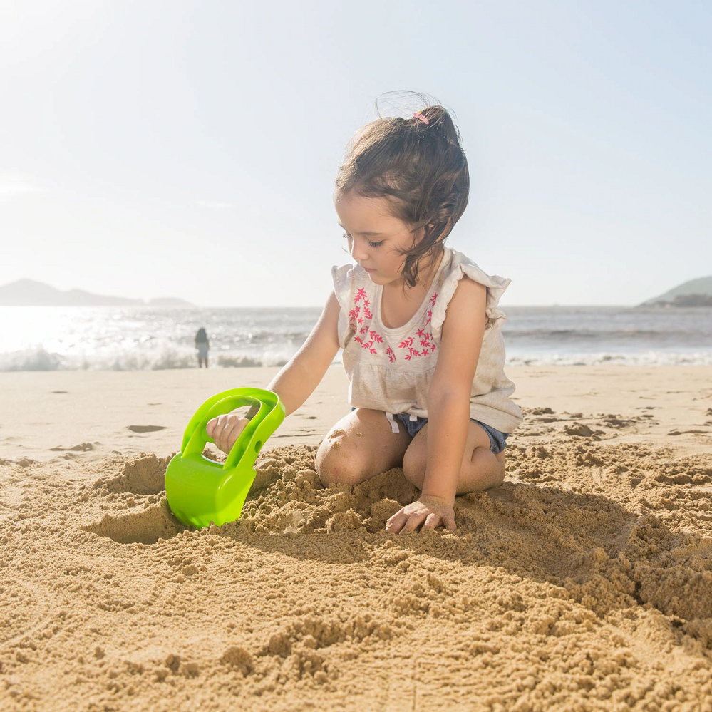 Child using Hape Green Hand Digger