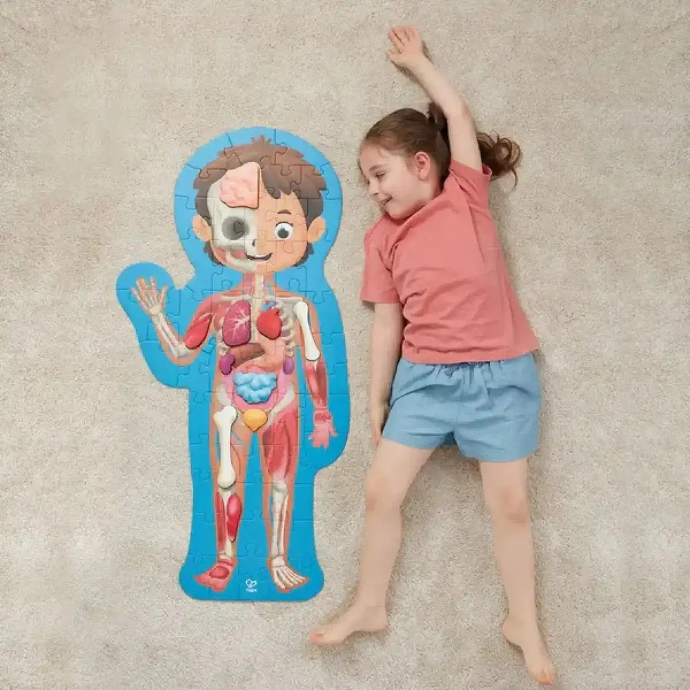Hape Human Body Life Size Puzzle next to girl