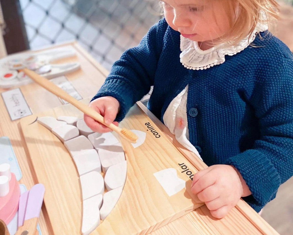 girl playing with qtoys tooth puzzle