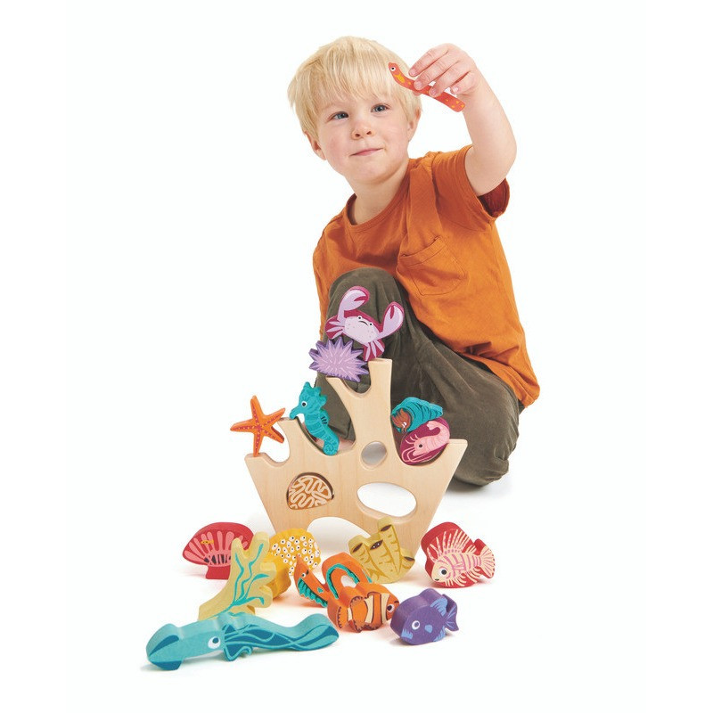 boy playing with tenderleaf coral reef stacking toy