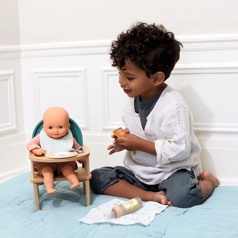 child playing with djeco baby doll high chair