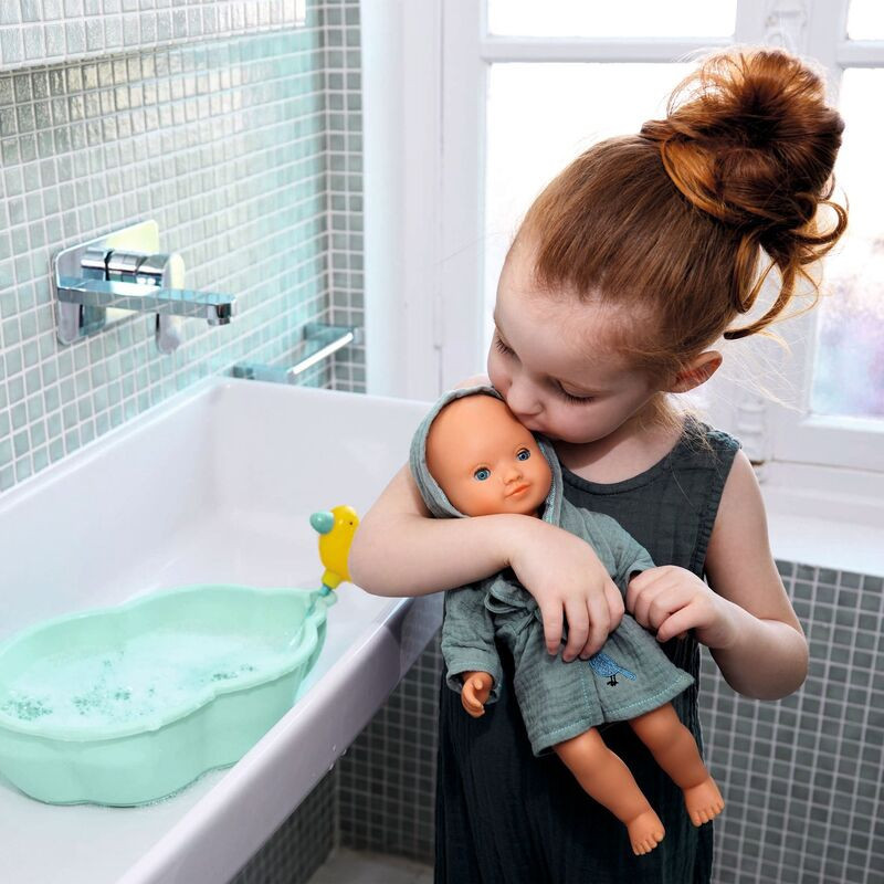 Child loving on Djeco Baby Boy Olive Pomea Hard Body Doll