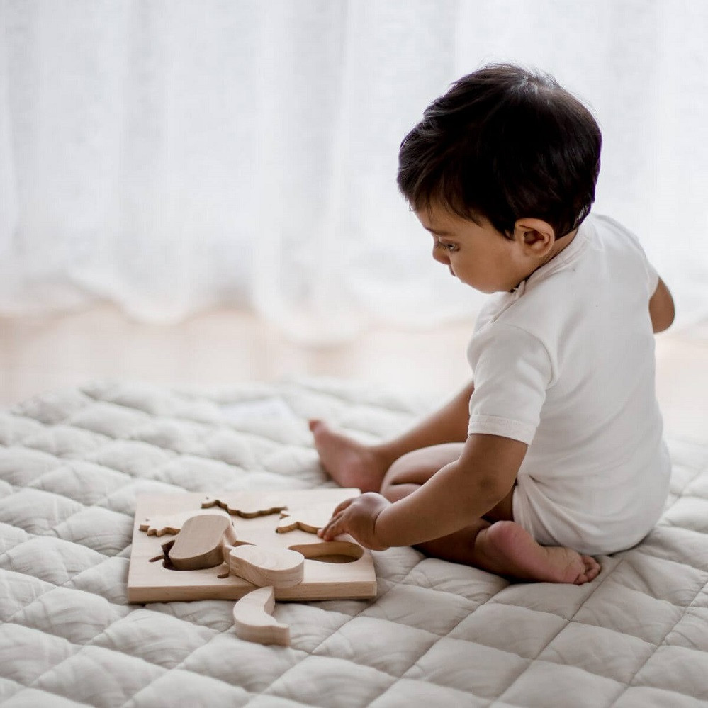 Child playing with Qtoys Fruit Puzzle