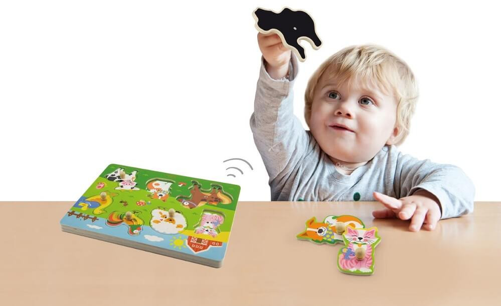 Toddler playing with Viga Sound Puzzle - Farm Animals