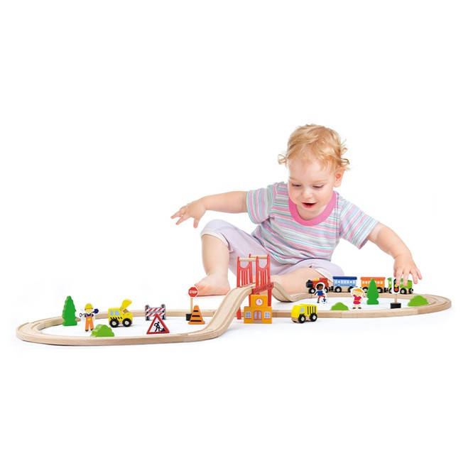 Toddler playing with Viga Train Set