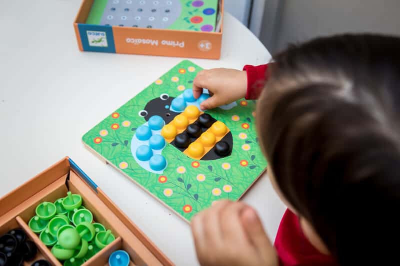 Child following a bee pattern on the Djeco Primo Mosaico Puzzle