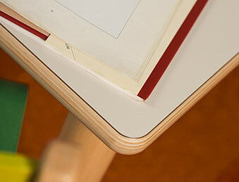 Montessori wood and white square table close up