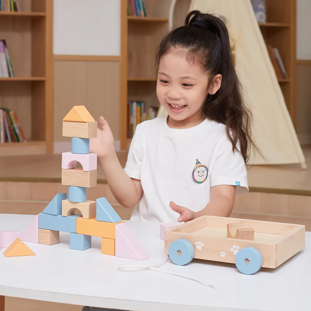 girl playing with mini block wagon