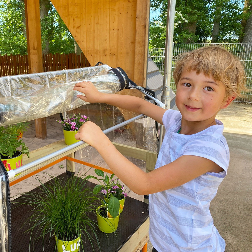 Beleduc Mobile Greenhouse for Kids - tending to plants