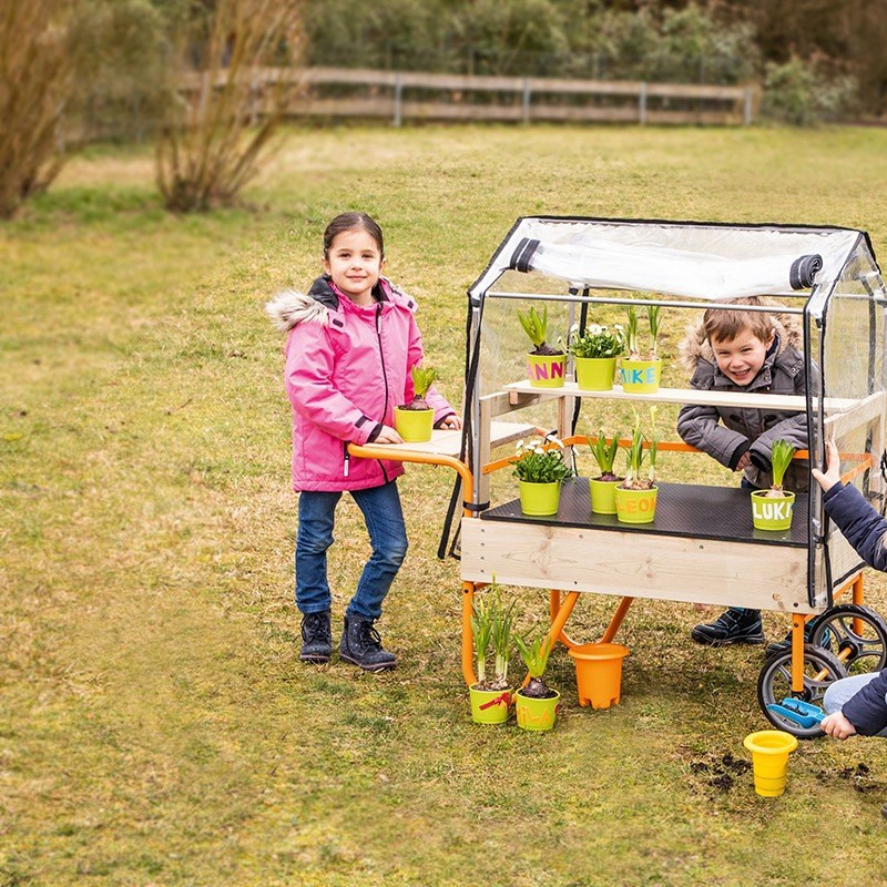 Beleduc Mobile Greenhouse for Kids pushing it along
