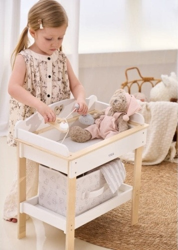 girl playing with viga pretend play changing table