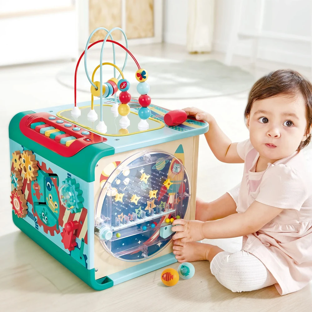 child playing with hape magic cube