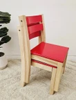 set of stackable red top wooden chairs