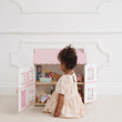 girl play with sophie doll house furnished