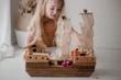 girl playing with wooden ship