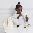 girl playing with wooden pretend play beauty set