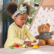 girl playing with pretend play breakfast cutting set with velcro items