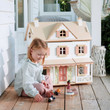 girl playing with accessories (sold separately) outside dollhouse