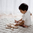 Child playing with Qtoys Fruit Puzzle