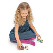 Child playing with Le Toy Van Retro Metro Car Set