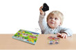 Toddler playing with Viga Sound Puzzle - Transportation