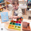 boy playing with qtoys wooden sorting container ship