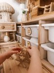 child playing with wooden balancing people toy