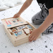 Child opening a box of Fun Factory Animal Shadow