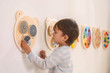 Child engaged with Viga Wall Toy - Spinning Points