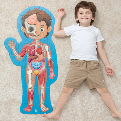 Hape Human Body Life Size Puzzle next to boy