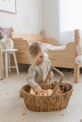girl playing with Qtoys Wicker Basket