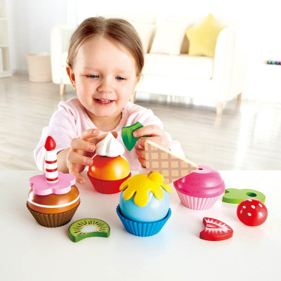Child playing with Hape Cupcakes