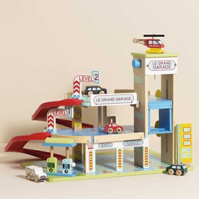 boy playing with le toy van grande wooden toy garage station
