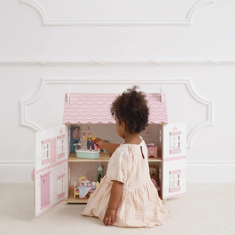 girl play with sophie doll house furnished