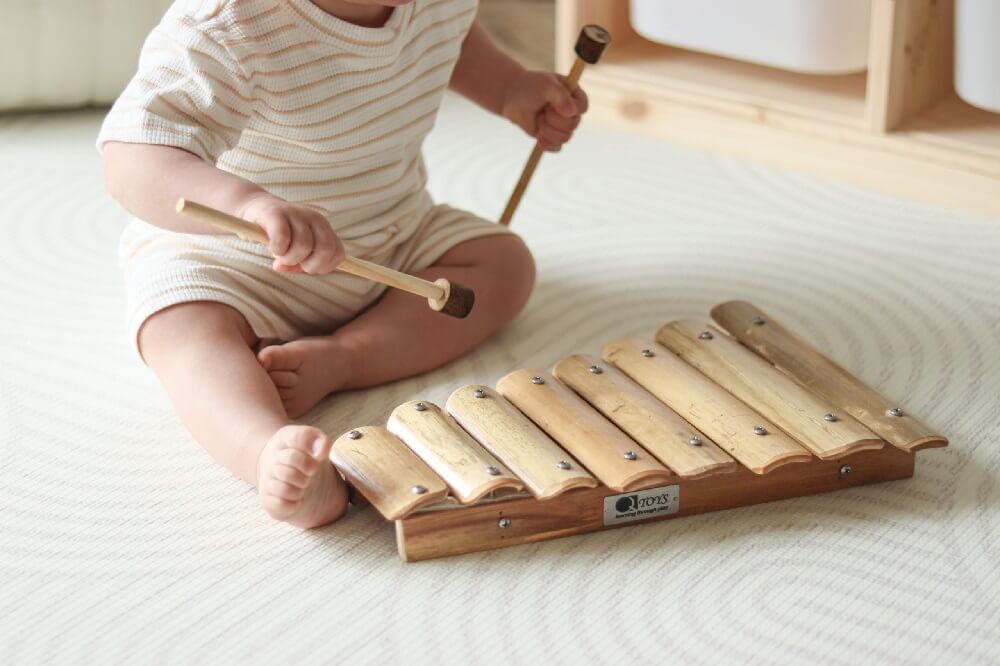 child playing with bamboo xylophone child playing with bamboo xylophone