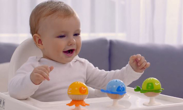 baby playing with hape suction cup rattles