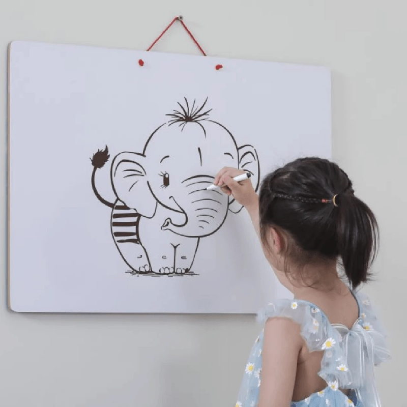 Kid drawing on whiteboard that comes with Viga World Magnetic Puzzle