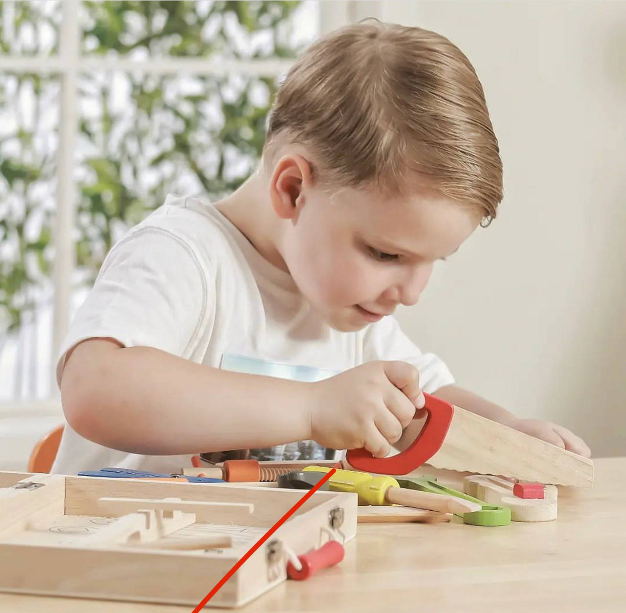 child playing with viga tool box