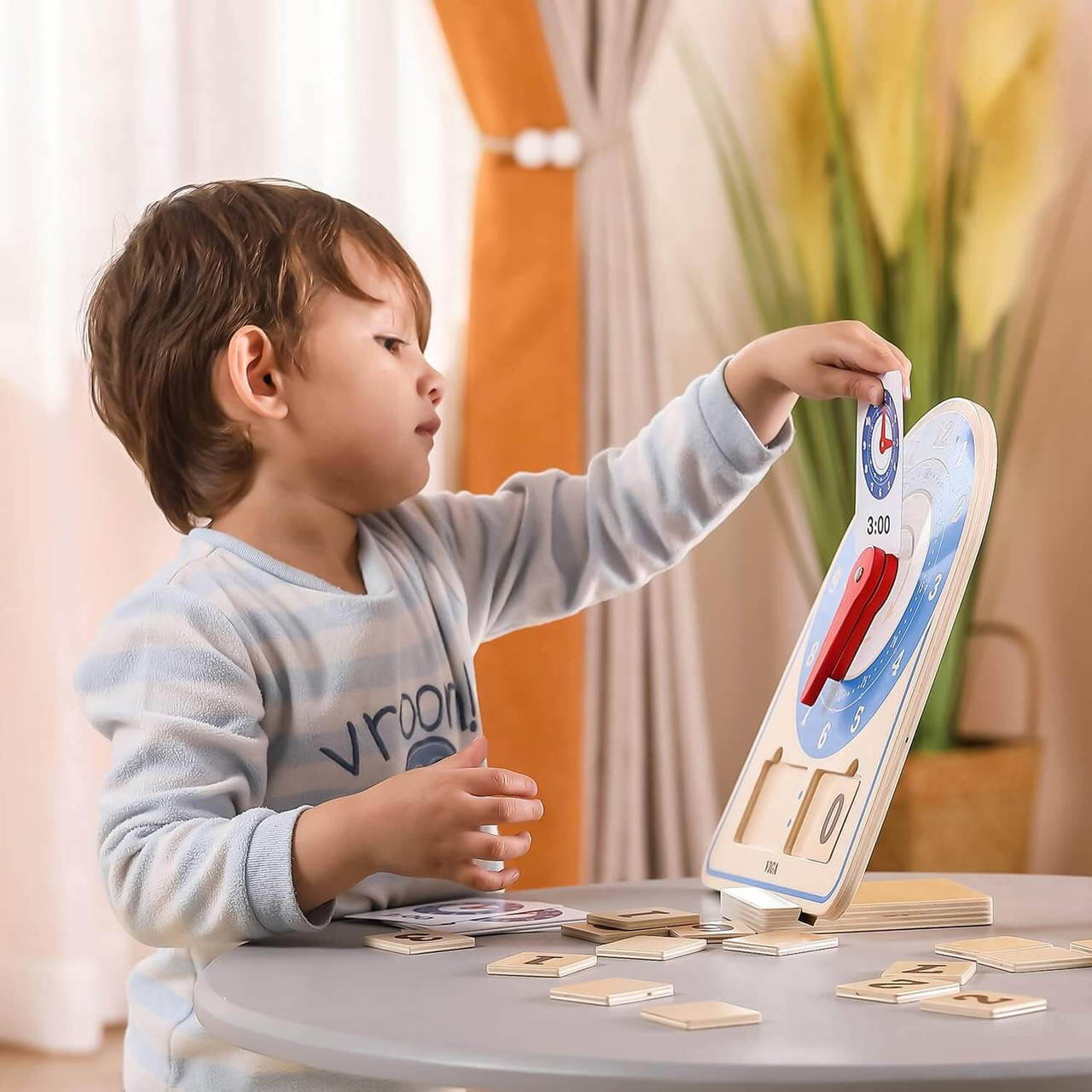 boy learning to tell the time with learning clock toy by viga