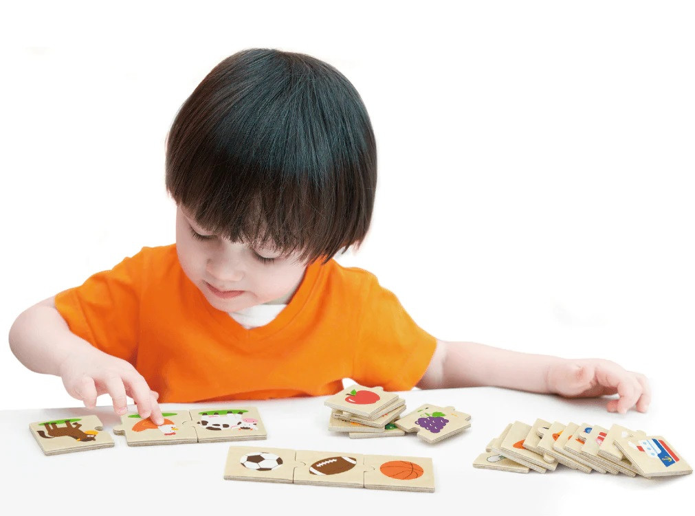 boy playing with viga category puzzle set