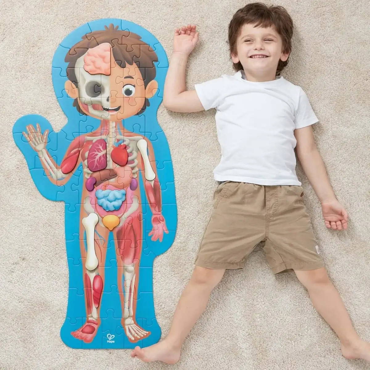 Hape Human Body Life Size Puzzle next to boy