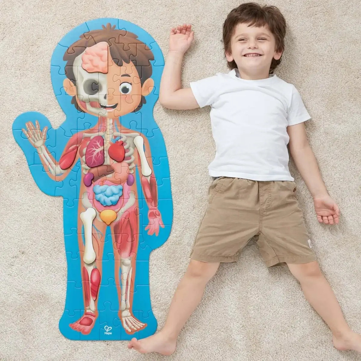 Hape Human Body Life Size Puzzle next to boy