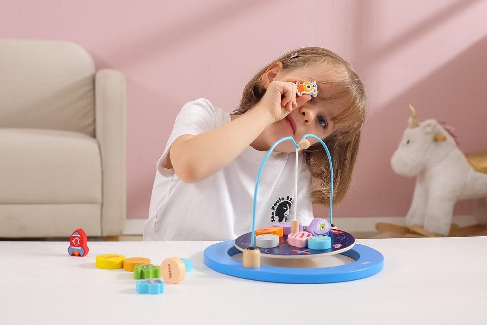 Children can build the model of the solar system using the wooden planets.