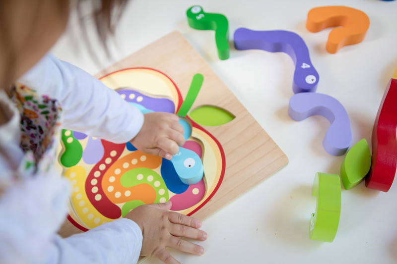 Child playing with Kiddie Connect Counting Worms Puzzle