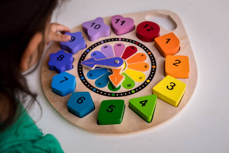 Child playing with Kiddie Connect Clock Puzzle